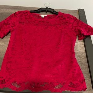A red lace blouse that is suitable for business casual.